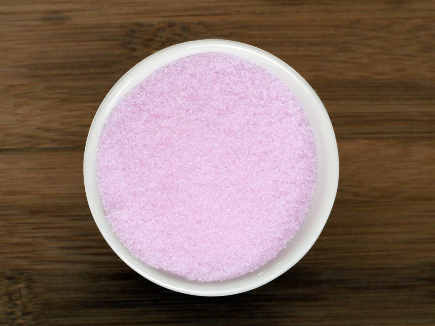 This is an image of a small white bowl containing Premium Pink Curing Salt from Anthony's Goods