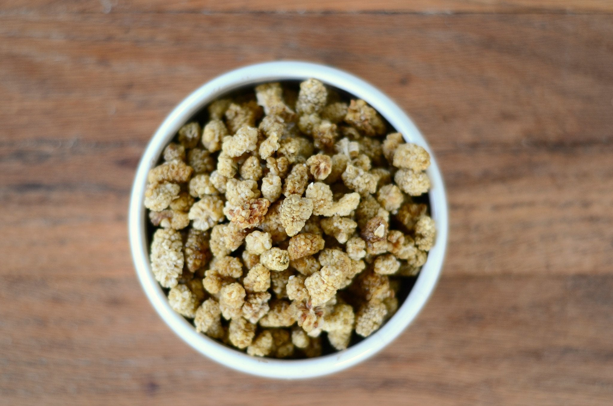This is an image of a small white bowl containing Organic White Mulberries from Anthony's Goods